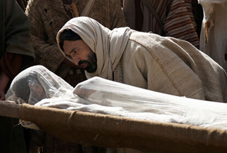 Image of man in a robe leANING